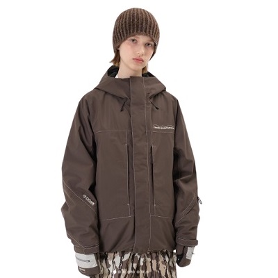 Model wearing a brown hooded waterproof jacket with zip front, matching gloves, knit beanie, and camo pants.