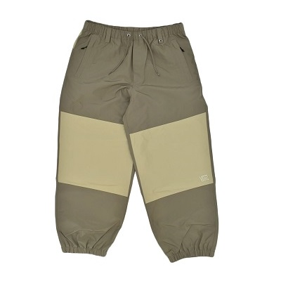 Two-tone olive jogger pants with beige knee-length panels and elastic cuffs at the ankles