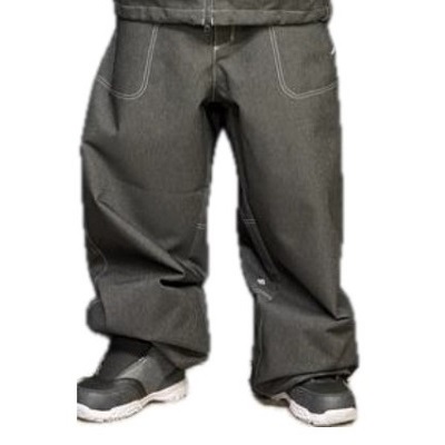 Lower half of a person wearing baggy dark-gray pants with white stitching and gray sneakers.