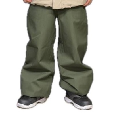Lower half of a person wearing oversized olive-green pants and black sneakers.