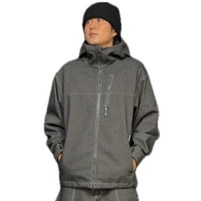 Man in a gray hooded jacket with hands in pockets and a black beanie, looking to the side.