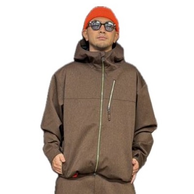 Person wearing a brown oversized winter jacket, orange knit beanie, and sunglasses, posing against a white background.