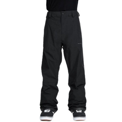 Lower body wearing black waterproof ski pants with sneakers, standing with feet apart.