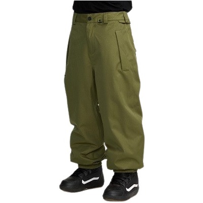 Person wearing olive green baggy cargo pants and black Nike sneakers with white logo on a plain background.