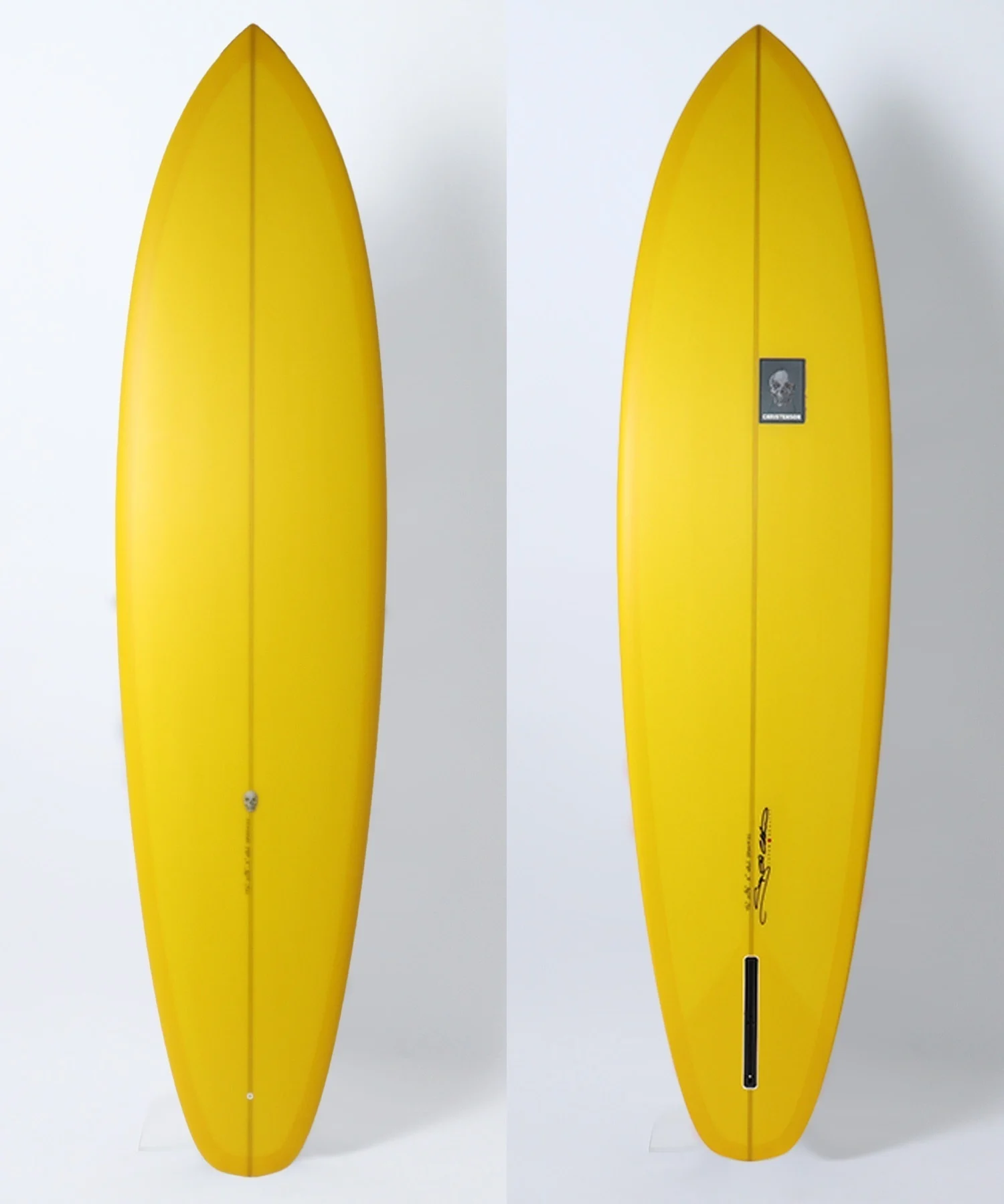 image - SHOP NEWS | ムラサキスポーツオンラインストア 通販 Yellow surfboard with a central seam, shown from two angles; the right image has a small logo sticker mid‑board.