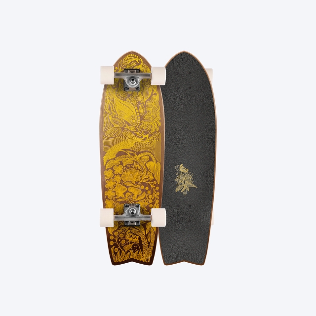 Two longboards standing upright side by side; one with yellow floral pattern, the other with black grip tape and a small gold emblem.