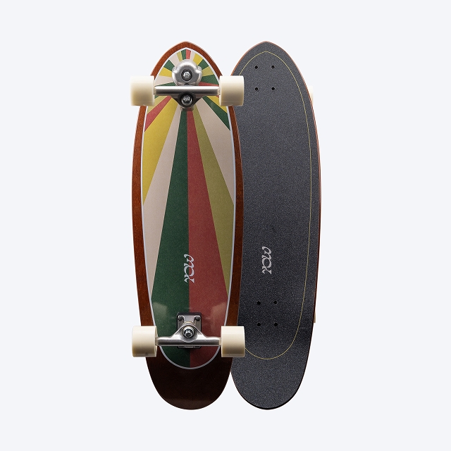 Two longboards standing upright side by side; one has a colorful striped deck with white wheels, the other a black grip-taped deck.