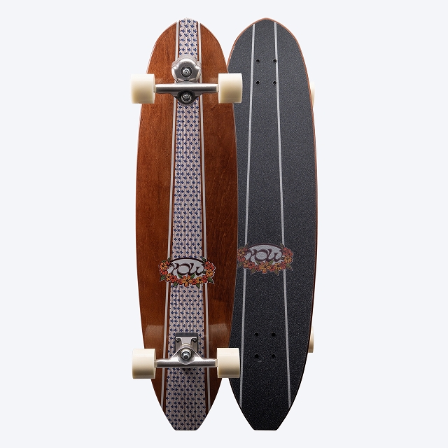 Two longboards standing upright side by side: one wooden with a patterned center stripe and logo, the other black with grip tape.