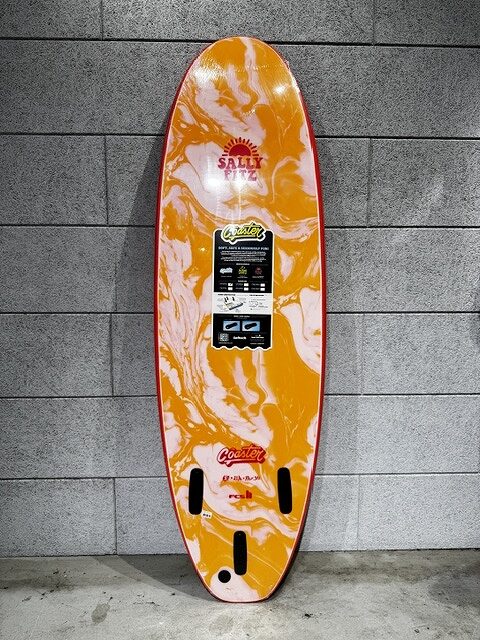 s-IMG_3795 - SHOP NEWS | ムラサキスポーツオンラインストア 通販 Orange and white marbled wakeboard leaning against a gray tile wall with a center branding label.