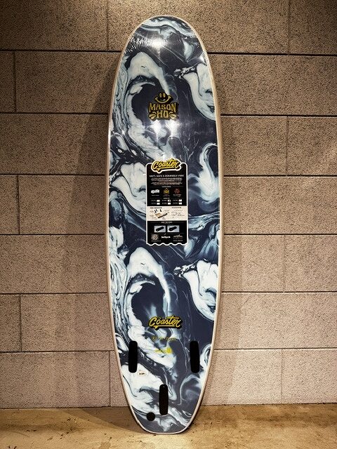 s-IMG_3797 - SHOP NEWS | ムラサキスポーツオンラインストア 通販 Vertical longboard deck with a black-and-white marble pattern leans against a tiled wall, featuring stickers and a central label.