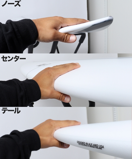 s-DRK_4 - SHOP NEWS | ムラサキスポーツオンラインストア 通販 Close-up of a hand gripping the nose of a white surfboard.