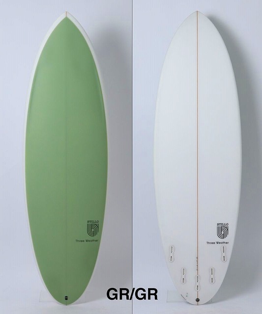 Two surfboards stand upright side by side: left green, right white with an orange stringer (GR/GR color variants).