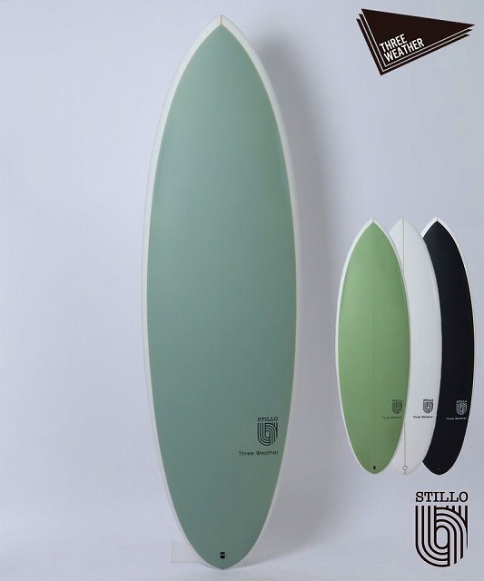 Four surfboards in pastel green, white, and black arranged against a pale wall, largest board in the foreground with brand logos nearby.