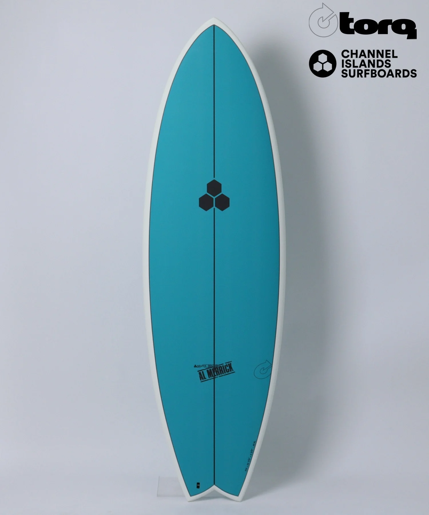 Turquoise surfboard standing upright with white edge, featuring black hexagon logo near center and logos on upper right corner: Torq and Channel Islands Surfboards (Al Merrick branding at bottom).