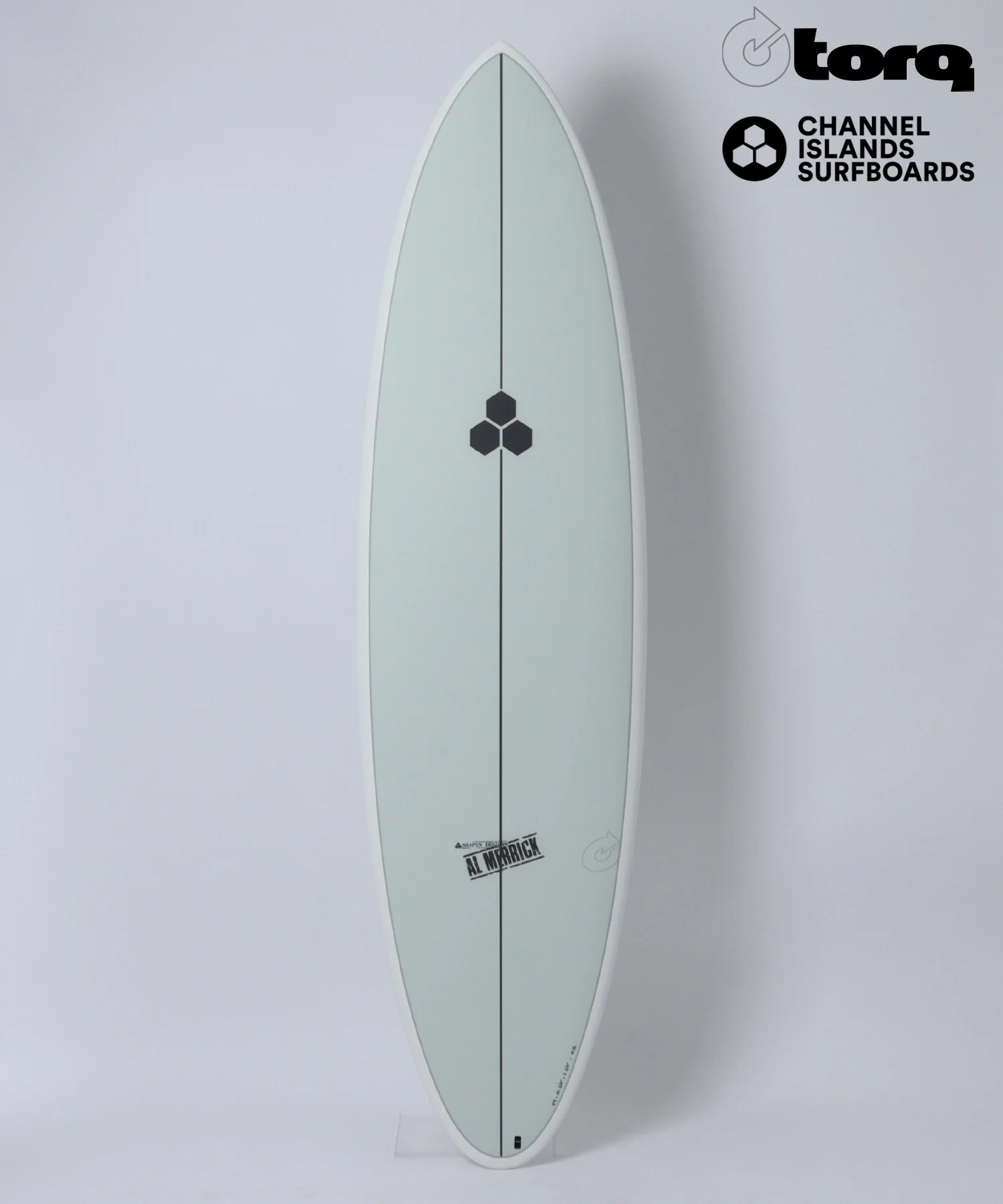 Pale gray surfboard standing upright against a white background with black hexagon logo midboard and brand logos in the top-right corner (Torq and Channel Islands Surfboards).
