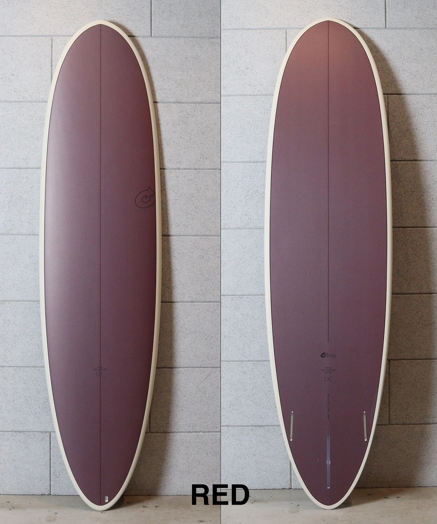Two burgundy surfboards with cream rails photographed against a gray tile wall, shown side by side; the word RED appears at the bottom edge.