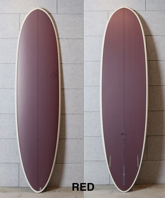 Two purple surfboards with cream rails, propped upright against a gray tiled wall.