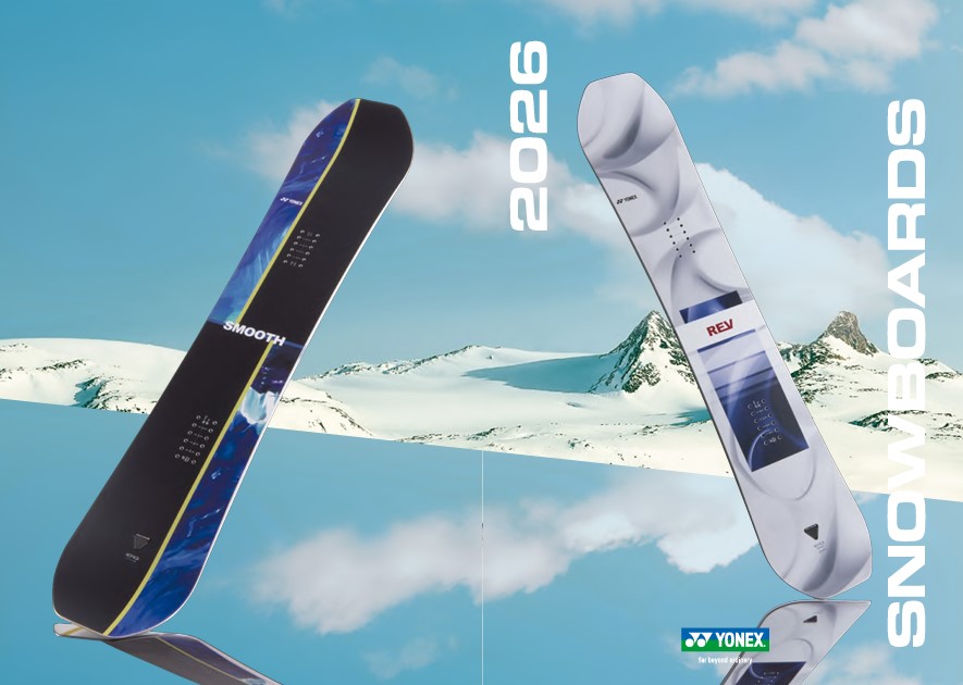 Two snowboards angled against a snowy mountain backdrop with bold vertical text reading 2026 and SNOWBOARDS; branding visible at bottom right (Yonex logo).
