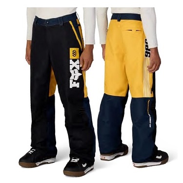 Two people wearing Fox motocross pants in black, yellow, and navy with logo visible on the left leg (front and back views).