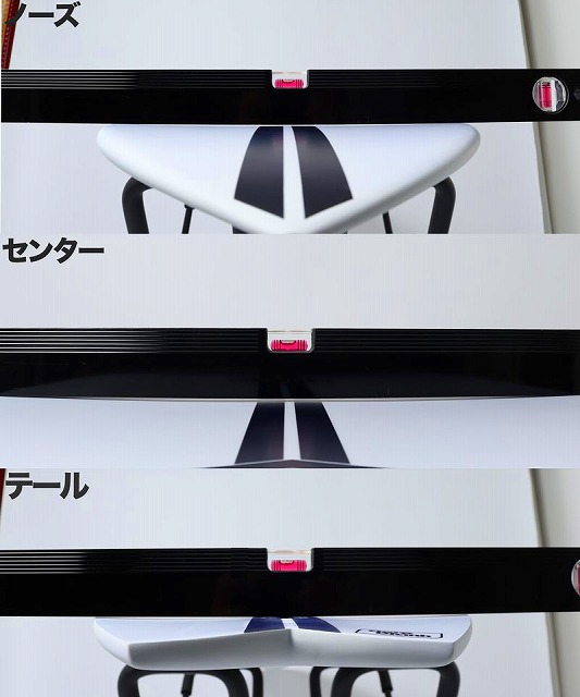 Vertical collage of white panels with black straps and pink badges, forming a black V shape; Japanese labels indicate center and tail.