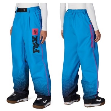 WS FOX PT - SHOP NEWS | ムラサキスポーツオンラインストア 通販 Front and back view of bright blue Fox snow pants with gradient dark hem, pink piping along the side, and a vertical Fox logo on the left leg. Sleeves and shoes visible for scale.