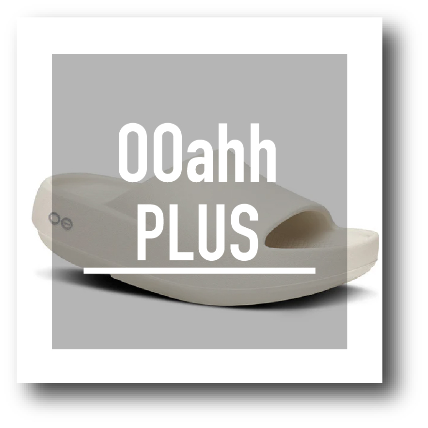 ooahhplus - SHOP NEWS | ムラサキスポーツオンラインストア 通販 Beige slide sandal on a gray square with white'00ahh PLUS' text overlay.