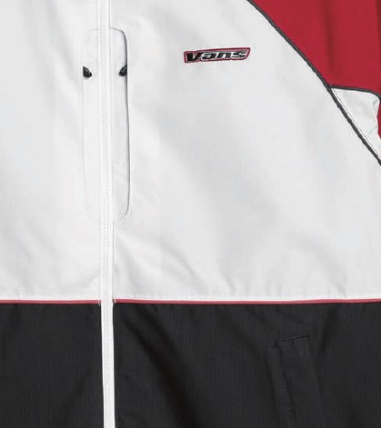 スクリーンショット 2026-05-30 193540 - SHOP NEWS | ムラサキスポーツオンラインストア 通販 Close-up of a color-blocked Vans windbreaker: white upper panel, black lower panel, red trim, and a zipper in the center.