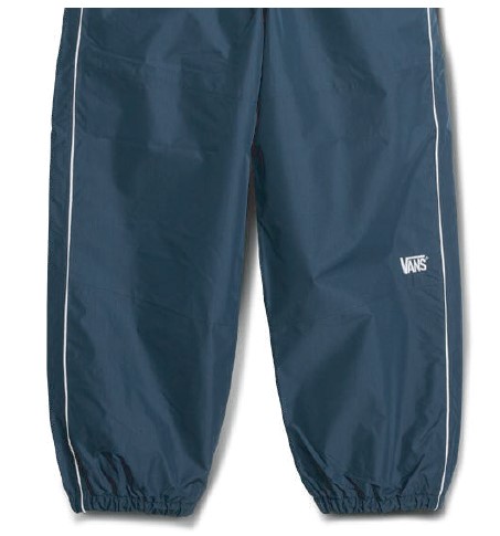 スクリーンショット 2026-05-30 194950 - SHOP NEWS | ムラサキスポーツオンラインストア 通販 Navy blue windbreaker pants with white piping along the sides and elastic cuffs; Vans logo on the right thigh.