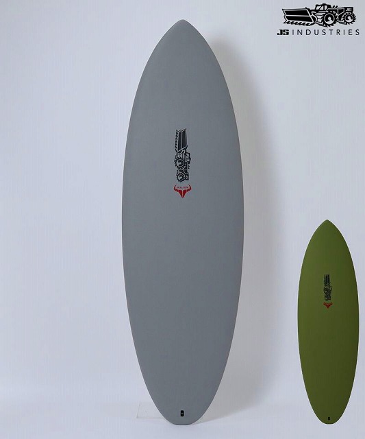 BULL RUN SOFT 1 - SHOP NEWS | ムラサキスポーツオンラインストア 通販 Two surfboards leaning against a white wall: a tall gray board and a shorter olive-green board, both with logos near the center, plus a JS Industries logo in the corner.