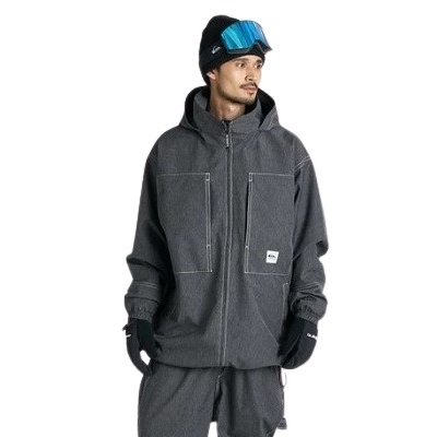 Man wearing a dark gray winter jacket with hood and matching pants, black gloves, and blue ski goggles on his head.