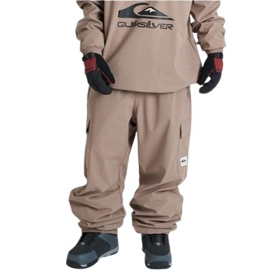 Lower half of a person wearing tan snow pants and black gloves, with dark snow boots, standing facing forward.