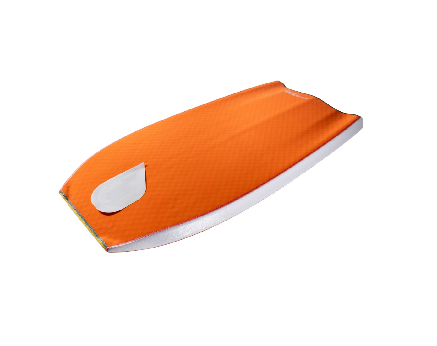 Orange textured board-like object with a white oval patch near one end, photographed at an oblique angle