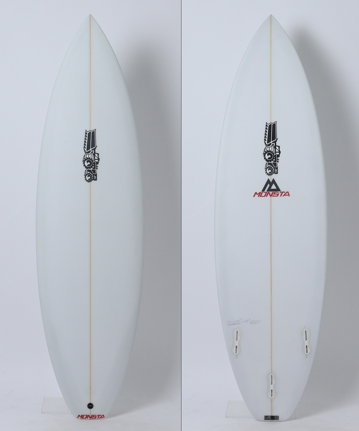 image - SHOP NEWS | ムラサキスポーツオンラインストア 通販 Front view of a white surfboard with a beige stringer, featuring a small black graphic logo midboard and the MONSTA logo near the tail on a light background (left panel). The board is oriented vertically with a rounded nose and single fin slot visible.