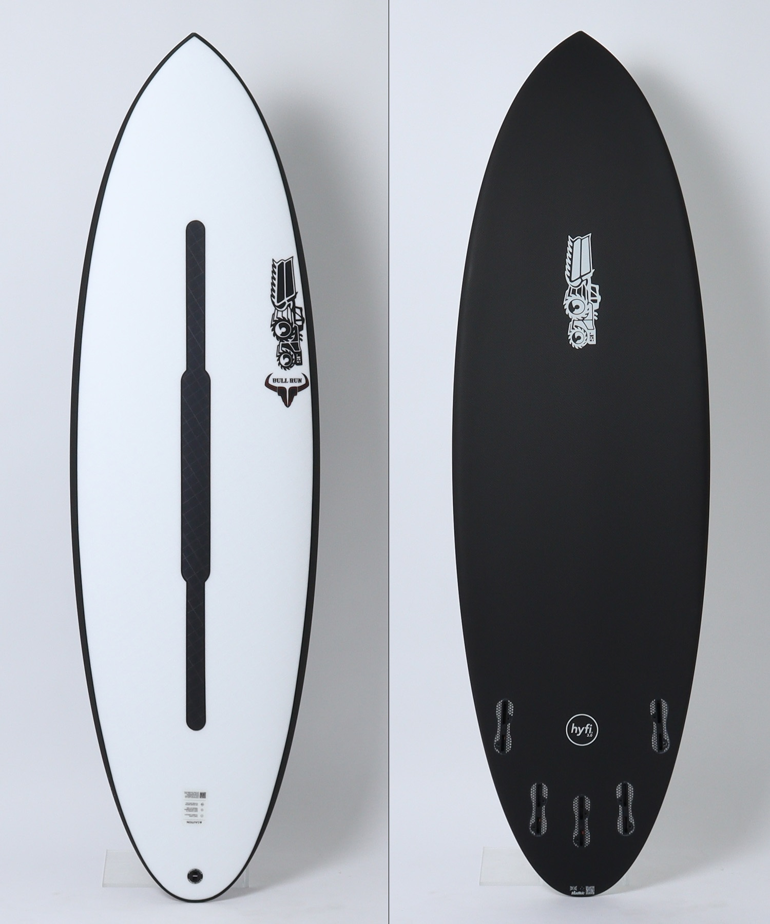 image - SHOP NEWS | ムラサキスポーツオンラインストア 通販 Side-by-side view of two surfboards: left a white deck with a black center channel and a Bull Run logo; right a black bottom with fin boxes and a logo.