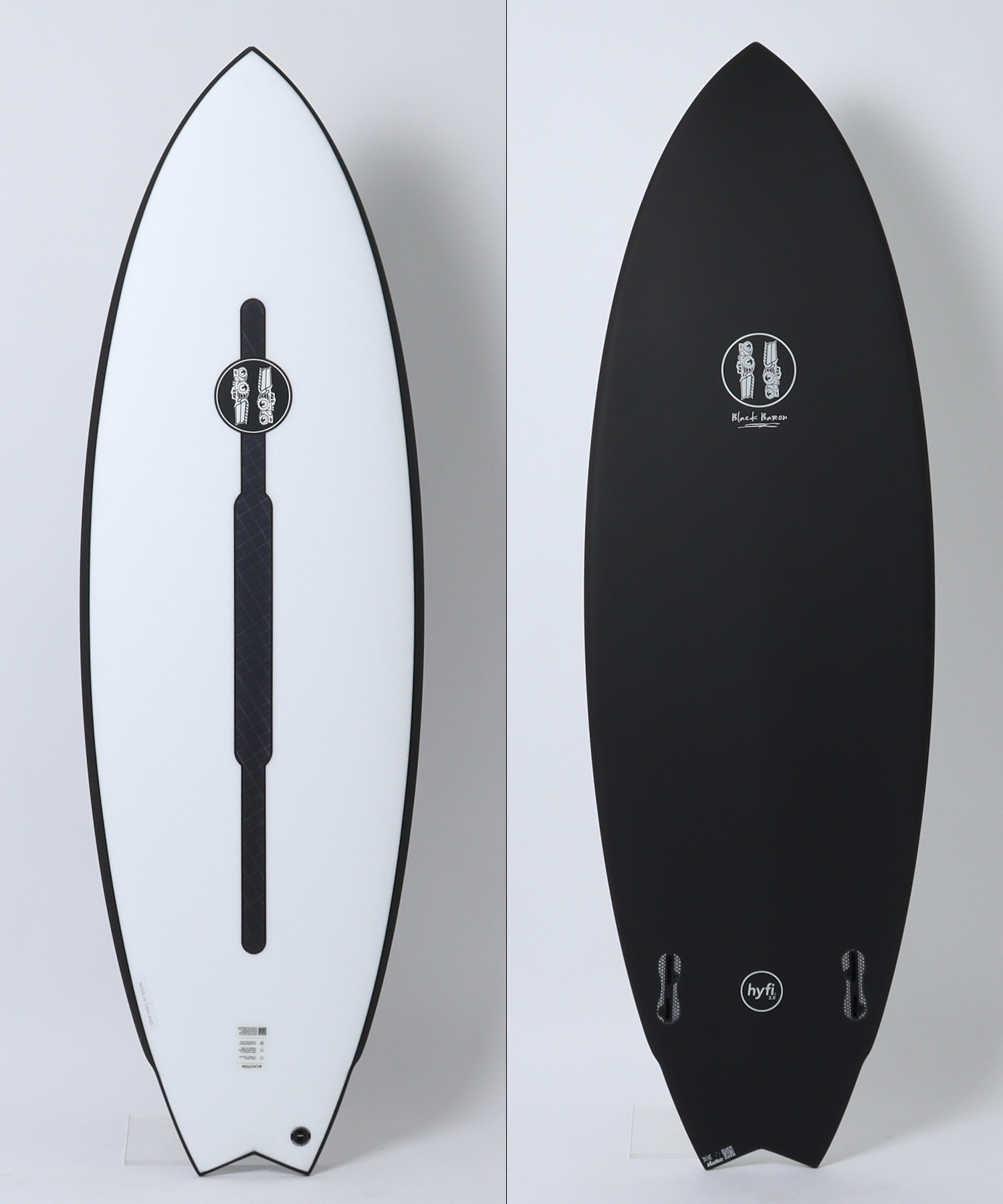 image - SHOP NEWS | ムラサキスポーツオンラインストア 通販 Two surfboards shown vertically side by side: the left board is white with a dark edge and a central black leash pad and logo; the right board is black with a small circular logo near the center.