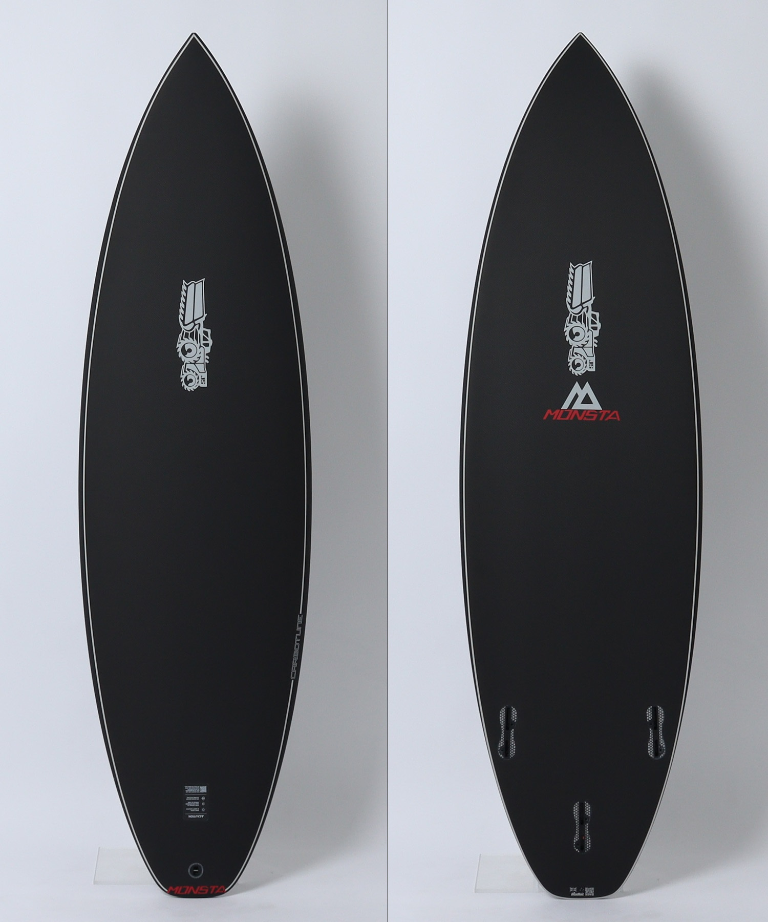 image - SHOP NEWS | ムラサキスポーツオンラインストア 通販 Two black surfboards with white rails shown from the front, left and right panels, featuring the MONSTA logo near the bottom.