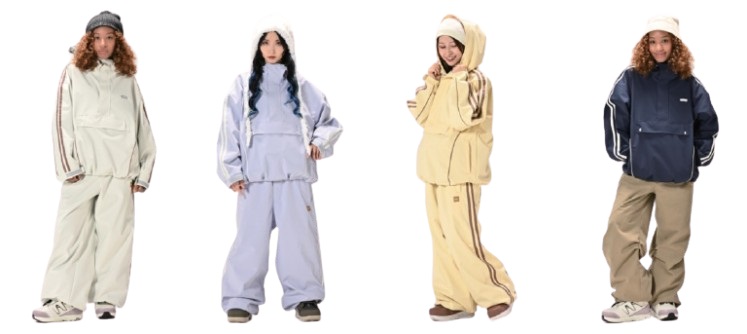 Four models wearing oversized tracksuits in cream, lavender, pale yellow, and navy on a white background.