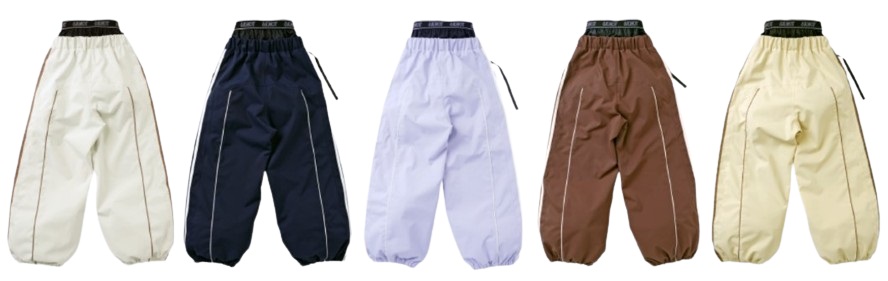 Five pairs of baggy track pants in cream, navy, lavender, brown, and beige lined up side by side.