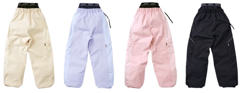 Four pairs of loose-fitting nylon pants in cream, lavender, pastel pink, and black, each with a drawstring waist and zippered pockets.